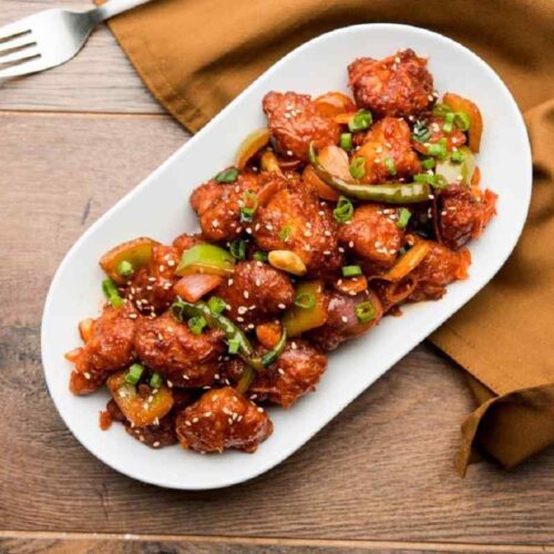 A plate of flavorful Manchurian Chicken, an irresistible delicacy.