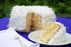 A delicious Mary Berry coconut cake on a white plate.