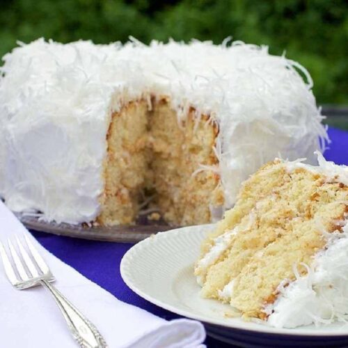 A delicious Mary Berry coconut cake on a white plate.