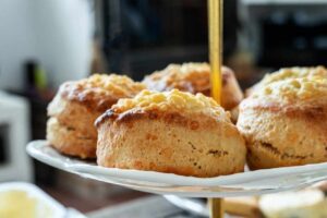 Close-up of golden-brown cheese scones with a fluffy interior.