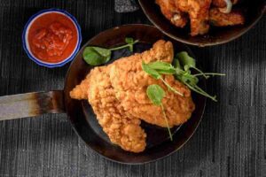 Golden-brown fried chicken breast on a plate