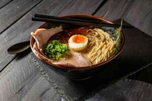 A steaming bowl of Japanese tonkotsu ramen, brimming with layers of flavor.