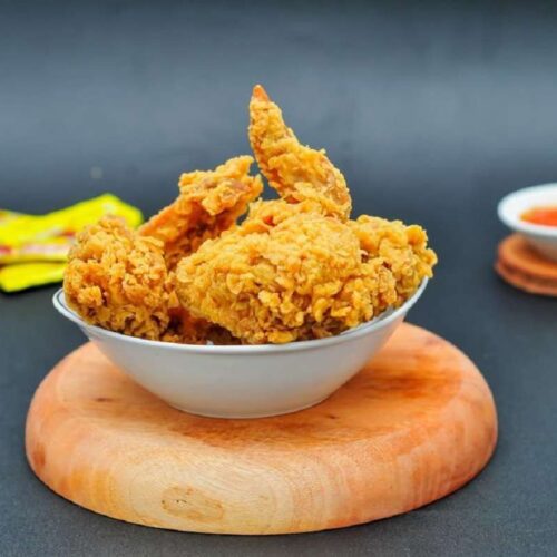 Bowl filled with golden-brown, crispy fried chicken