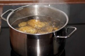 Fresh potatoes cooking in a simmering pot