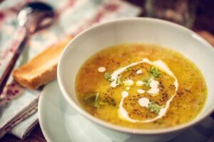 Creamy carrot and parsnip soup garnished with fresh parsley